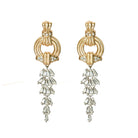 Gold earrings with diamond-like stones on a white background